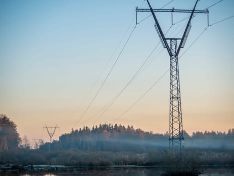 Rural landscape, the wires go into the mist. Russia, Moscow region