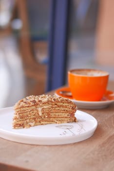 caramel cake and a coffee cup on table ,