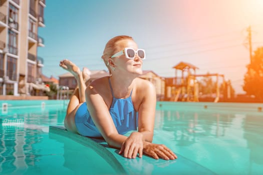 Bikini-clad woman enjoys poolside relaxation. Poolside ambiance. Capturing woman's relaxed time near pool