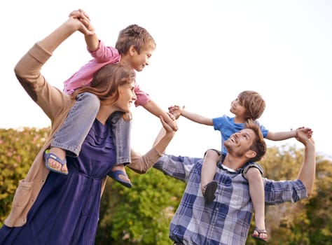 Excited, nature and children on parents shoulders in outdoor park or field for playing together. Happy, bonding and young mother and father carrying boy kids for fun in garden in Canada for summer