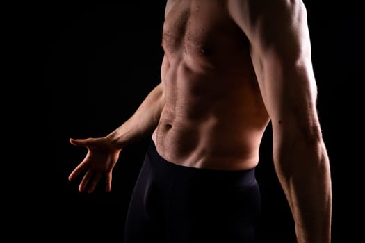 Image of muscle man posing in a studio, dark white red background