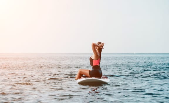 Sea woman sup. Silhouette of happy young woman in pink bikini, surfing on SUP board, confident paddling through water surface. Idyllic sunset. Active lifestyle at sea or river. Slow motion