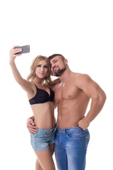 Cute couple athletes doing selfie on mobile phone. Isolated over white background