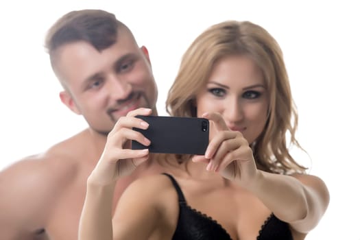 Couple doing selfie. Focus on mobile phone, close-up