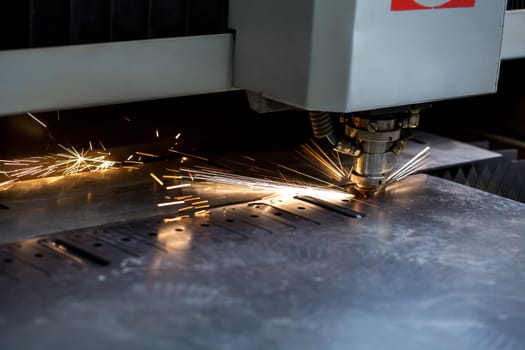 Image of modern automated machine laser cutting metal sheet