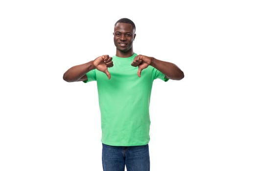 young charismatic american guy promoter dressed in a mint t-shirt on a white background.