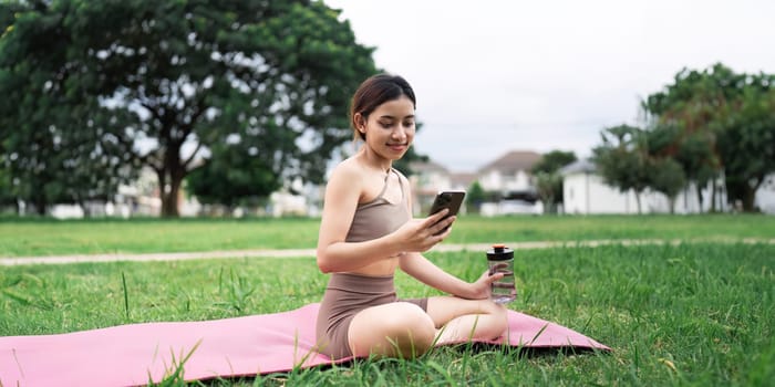 Exercise, relax and woman with phone on floor reading email or text after yoga workout at gym.