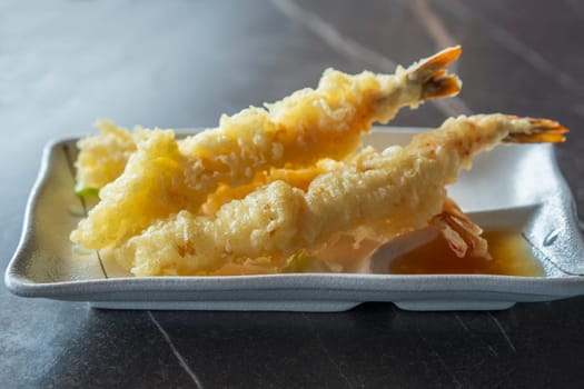 Close up view of prepared Japanese prawns tempura recipe with ginger ponzu sauce.