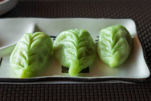 Green japanese dumplings Gyoza with vegetables close up