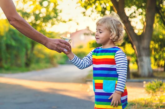 the father gives the child a glass of water. Selective focus. Kid.