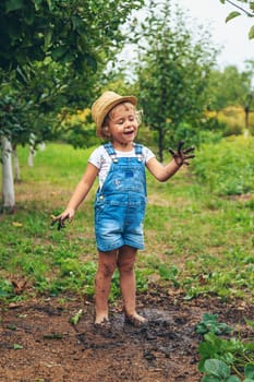 a child plants strawberries in the garden. Selective focus. nature.