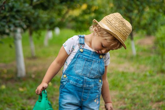 a child in the dirt in the garden holds the soil in his hands. Selective focus. Kid.