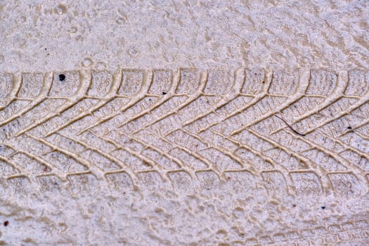 Texture of wet sand with Wheel track background