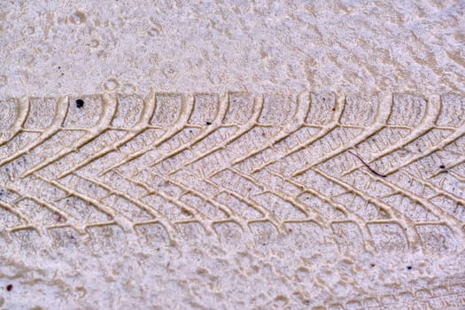 Texture of wet sand with Wheel track background