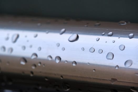 Water drops on a metal pipe