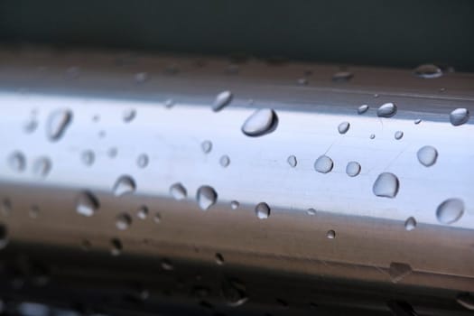 Water drops on a metal pipe