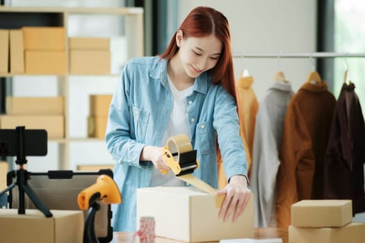 Woman packing box, package and cargo with tape for delivery, sale and shipping in workshop, startup store and creative studio.