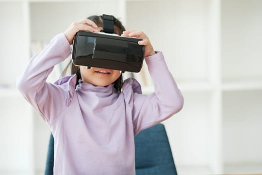 An elementary aged girl uses a virtual reality headset to enhance learning experience with excitement. Marketing for VR products, educational technology content.