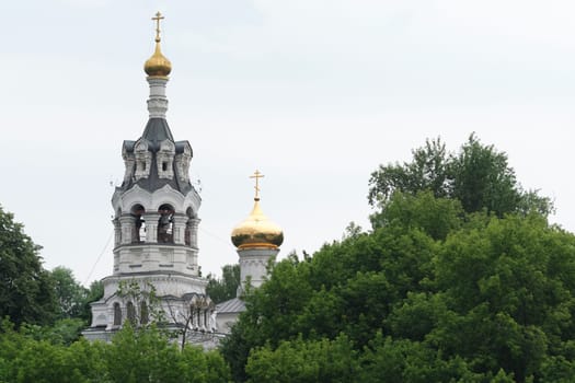 Russia-2020. Church domes of the Orthodox Church behind the trees. general plan. daylight