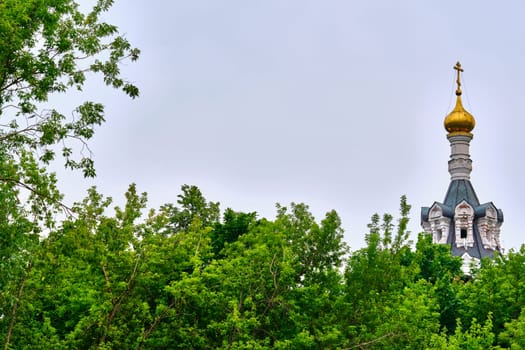 Russia-2020. Church domes of the Orthodox Church behind the trees. general plan. daylight