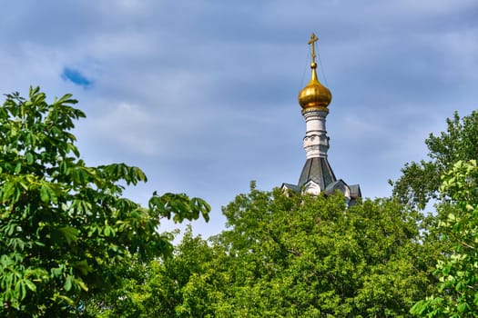 Russia-2020. Church domes of the Orthodox Church behind the trees. general plan. daylight