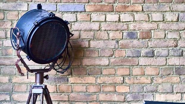 studio lamp against the background of a brick wall