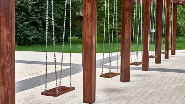 empty swings for children in the city park. master plan. color