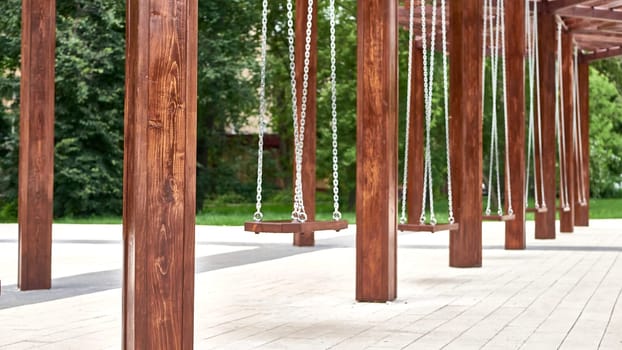 empty swings for children in the city park. master plan. color