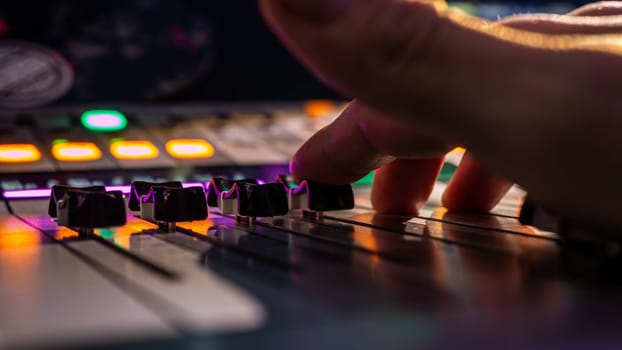 Sound engineer works with sound mixer, hands close-up