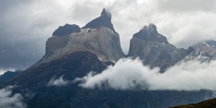 Mountain peaks emerge from thick clouds, offering a striking vista.