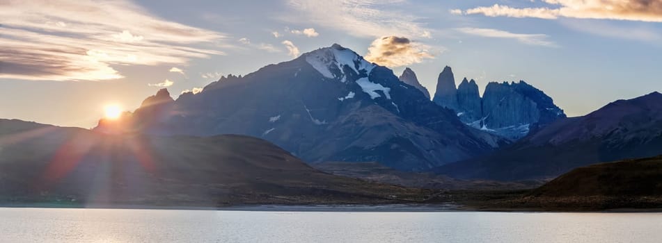 Sunrise in Patagonia with a tranquil lake and snow-capped mountains in the background, Torres del Paine sunset