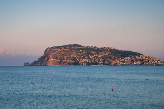 Beautiful sunrise scene on Alanya beach with view to famous Alanya island, in Turkey