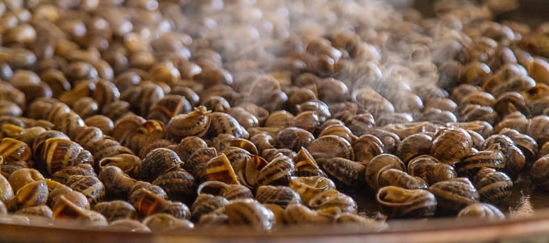 escargot is fried in a frying pan. Selective focus. food.