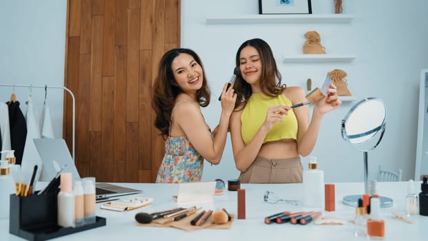 Two influencer partner shoot live streaming vlog video review makeup social media or blog. Happy young girl with vivancy cosmetics studio lighting for marketing recording session broadcasting online.