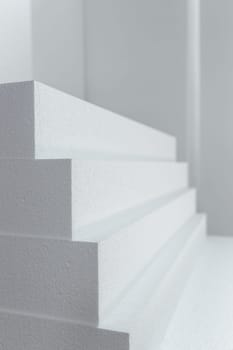 Close up of large panels of Styrofoam are stacked in a warehouse. Industrial production of polystyrene foam insulation panels or plates from expanded polystyrene. Building materials.