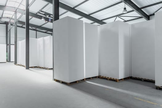 A large blocks of Styrofoam are stacked in a warehouse. Industrial production of polystyrene foam insulation panels or plates from expanded polystyrene. Building materials.