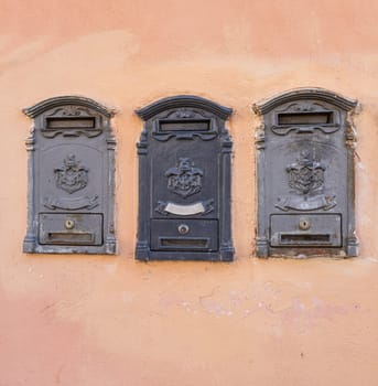 ancient letterboxes with the coat of arms of the old Italian royal house on a wall