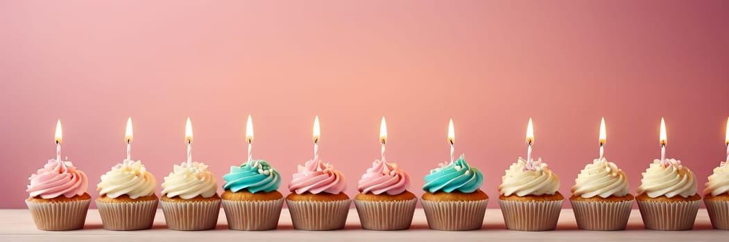 Colorful cupcakes with lit candles are displayed against a pink background, indicating an indoor celebration event marking of joy and celebrating. banner with free space.