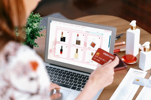 Woman shopping online on internet marketplace browsing for sale items for modern lifestyle and use credit card for online payment from wallet protected by utmost cyber security software