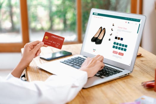 Woman shopping online on internet marketplace browsing for sale items for modern lifestyle and use credit card for online payment from wallet protected by uttermost cyber security software