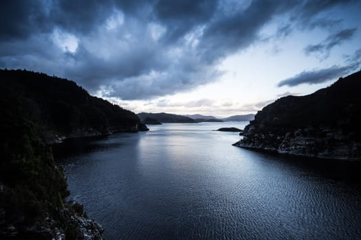 View of the Gordon Dam on a cool summer's day. It is a unique double curvature concrete arch dam with a spillway across the Gordon River near Strathgordon, South West Tasmania, Australia