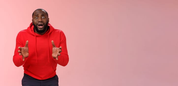 Worried guy asking be careful look how carelessly employee carry fragule things frowning look concerned bending gesturing shocked perplexed standing nervously pink background. Copy space