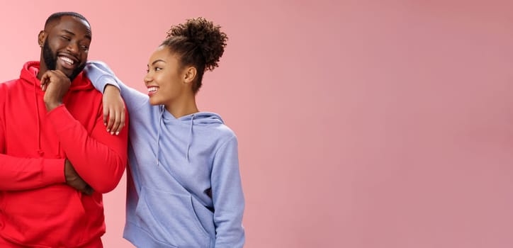 Two best friends having fun man smiling woman leaning his shoulder talking laughing joking like spending time together, standing pink background chit-chat confident relaxed poses. Copy space