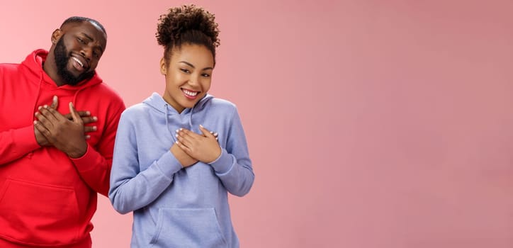 Couple receive compliments look good together. Portrait charming friendly loving african-american girlfriend boyfriend press palms heart touched pleased smiling broadly grateful moving words.