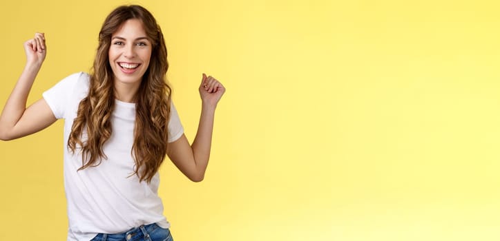 Oh yes check out my moves. Cheeky stylish good-looking young woman having fun party all night smiling delighted dancing lift hands up fist pump celebration success gesture grinning satisfied.