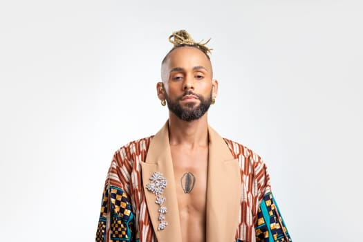 African-american guy wearing vibrant stylish jacket posing isolated on white background. Looking at camera with serious face young millennial man