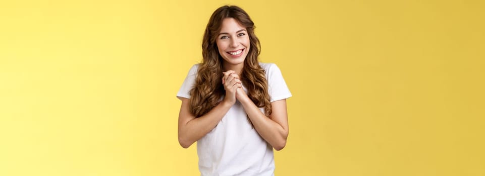 Cute lovely silly attractive female coworker appreciate friends farewell party office clasp hands thanking everyone awesome event smiling broadly delighted love adore you stand yellow background. Lifestyle.