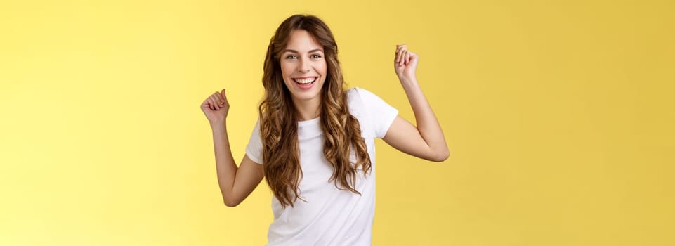 Oh yes check out my moves. Cheeky stylish good-looking young woman having fun party all night smiling delighted dancing lift hands up fist pump celebration success gesture grinning satisfied.