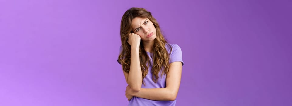 Moody sulking cute girlfriend showing attitude tilt head lean fist frowning pouting hold breath not speak offended exress insult disapproval standing upset gloomy whining boredom purple background. Lifestyle.