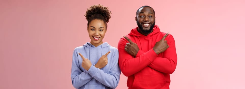 Lifestyle. Charming happy couple african american boyfriend girlfriend move in together pointing different sides cross arms chest left right smiling broadly upbeat have variety good choices opportunities.